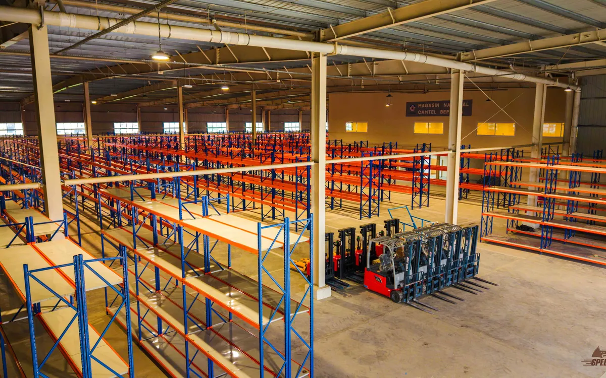 Entrepôt CAMTEL avec racks et engins de manutention